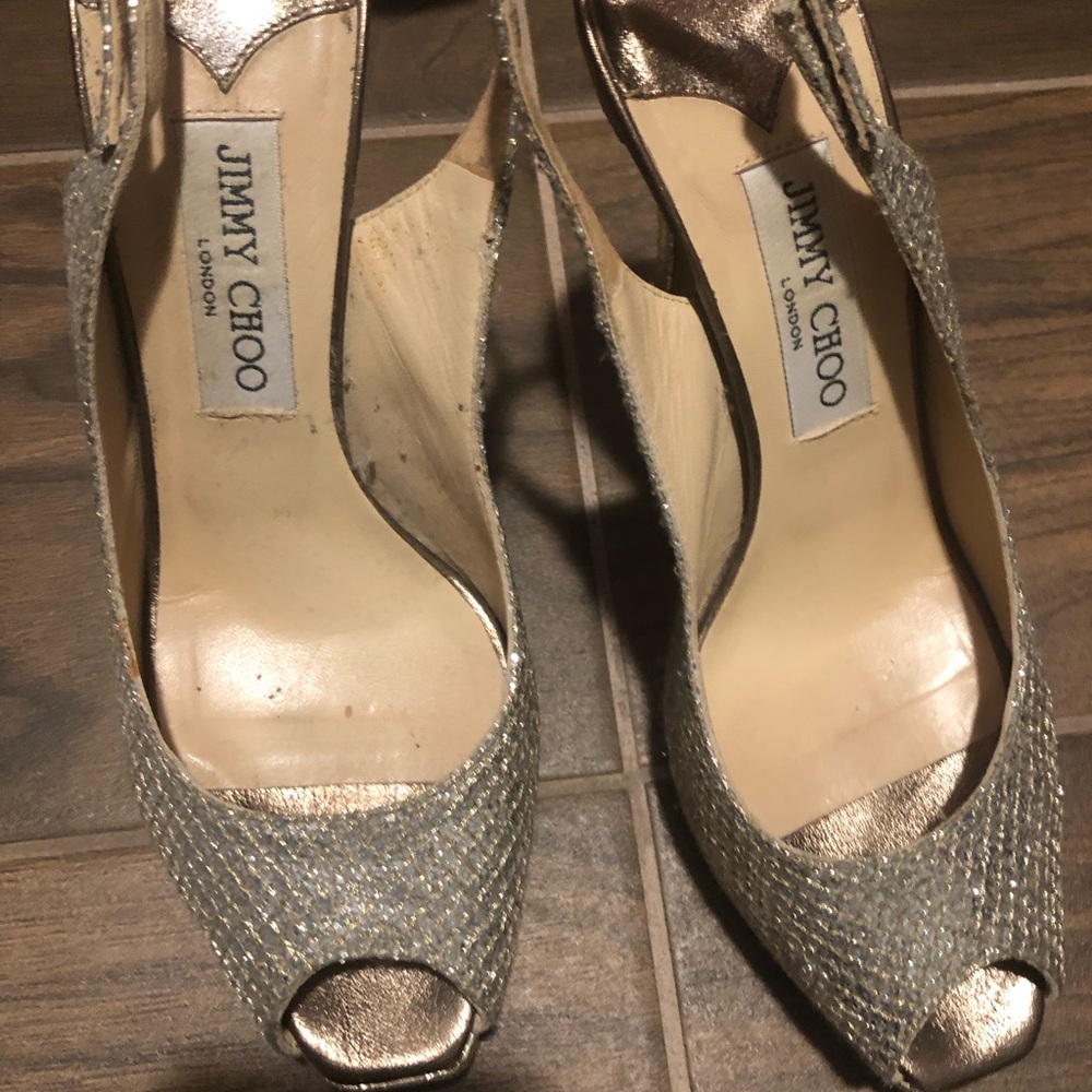 Jimmy Choo Pumps
Patent Leather Trim
Peep-Toes with Glitter Accents
Stiletto - Picture 2 of 3
